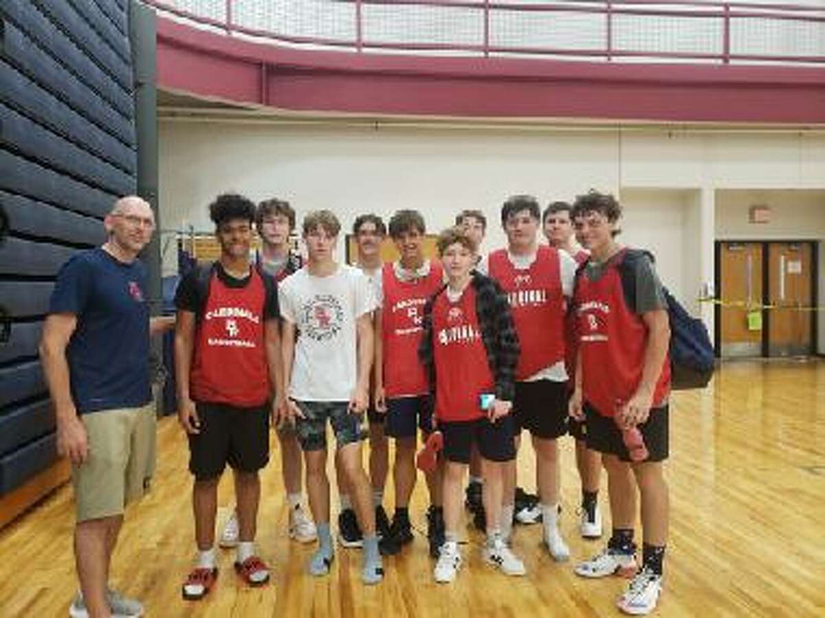 Brennan Walsh (at left) is pictured with Big Rapids basketball players while he was an assistant coach with the Cardinals. He is in his first season as Reed City varsity coach.