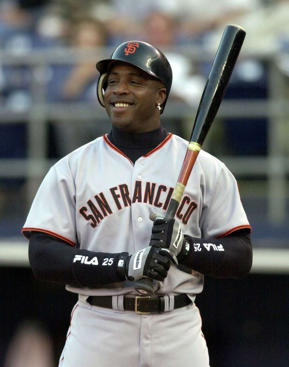 ** ADVANCE FOR WEEKEND EDITIONS, JUNE 15-16 -- FILE --** San Francisco Giants' Barry Bonds sports a big grin as he is intentionally walked in the first inning of the Giants game against the San Diego Padres in San Diego, in this June 3, 2002 photo. In 1998, Arizona manager Buck Showalter considered Bonds such a threat that he had him intentionally walked with the bases loaded. And that was years before Barry Bonds broke the single-season home run record.(AP Photo/Denis Poroy)