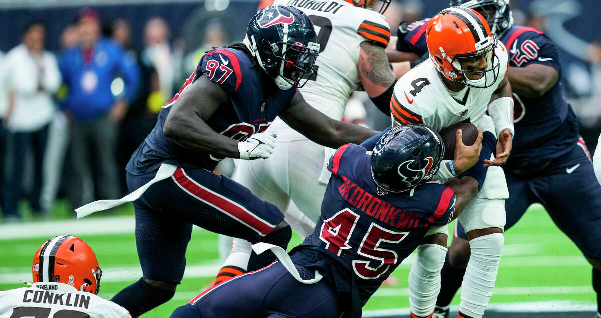Texans linebacker Ogbonnia Okoronkwo (45) and defensive end Michael Dwumfour (50) sack Browns quarterback Deshaun Watson, who in his return Sunday had a career-low passer rating of 53.4.  