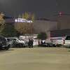 Police investigate the scene where two people died in an apparent murder-suicide Sunday, Dec. 4, 2022, in the parking lot at Texas Children's Hospital West Campus in Houston.