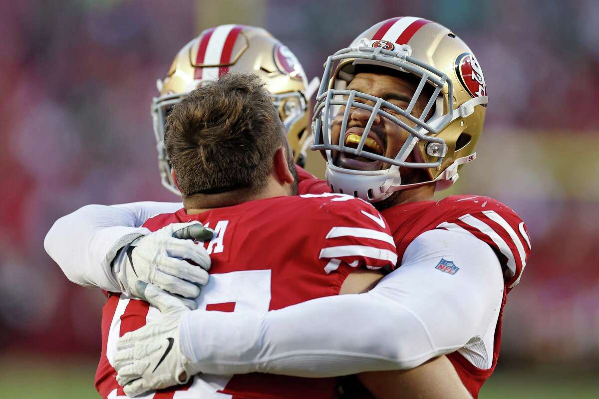 SANTA CLARA, CALIFORNIA - DECEMBER 04: Arik Armstead #91 of the San Francisco 49ers celebrates with Nick Bosa #97 of the San Francisco 49ers after Bosa's forced fumble was returned for a San Francisco 49ers touchdown during the fourth quarter against the Miami Dolphins at Levi's Stadium on December 04, 2022 in Santa Clara, California. (Photo by Ezra Shaw/Getty Images)
