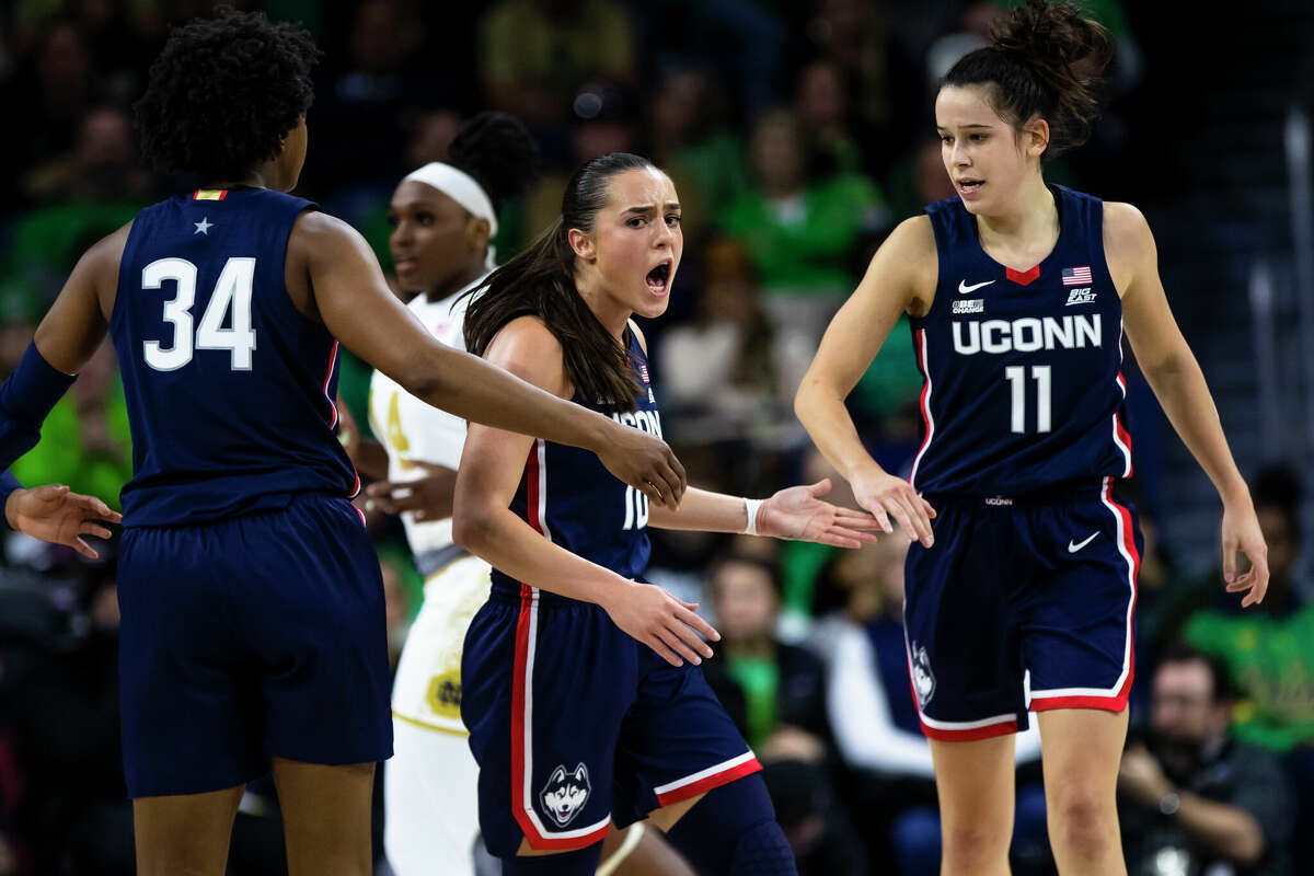 Connecticut's Nika MÃ¼hl, center, celebrates with Lou Lopez SÃ©nÃ©chal (11) and Ayanna Patterson (34) during the second half of an NCAA college basketball game against Notre Dame on Sunday, Dec. 4, 2022, in South Bend, Ind. (AP Photo/Michael Caterina)