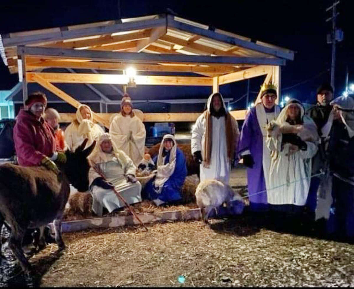 The Altar Society at St. Ann Catholic Church, in Baldwin, hosted a living nativity Saturday, Dec. 3. Members of the cast gather in the handmade manger.