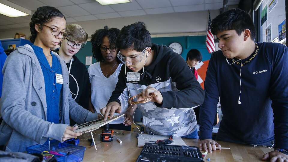 Students work on a motorized panel describing the advances in hydropower over the course of history at the Energy Institute High School, a STEM-focused magnet school in Houston ISD, Tuesday, Jan. 30, 2018 in Houston. ( Michael Ciaglo / Houston Chronicle)