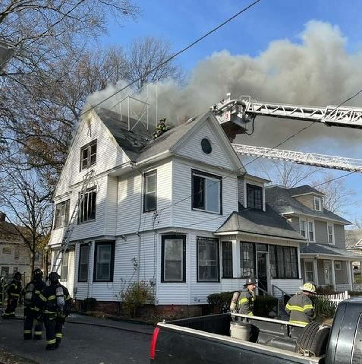 Firefighters battled a two-alarm house fire on Vine Street in Hartford Monday afternoon, rescuing two occupants trapped on the third floor, according to fire officials.