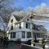 Firefighters battled a two-alarm house fire on Vine Street in Hartford Monday. 