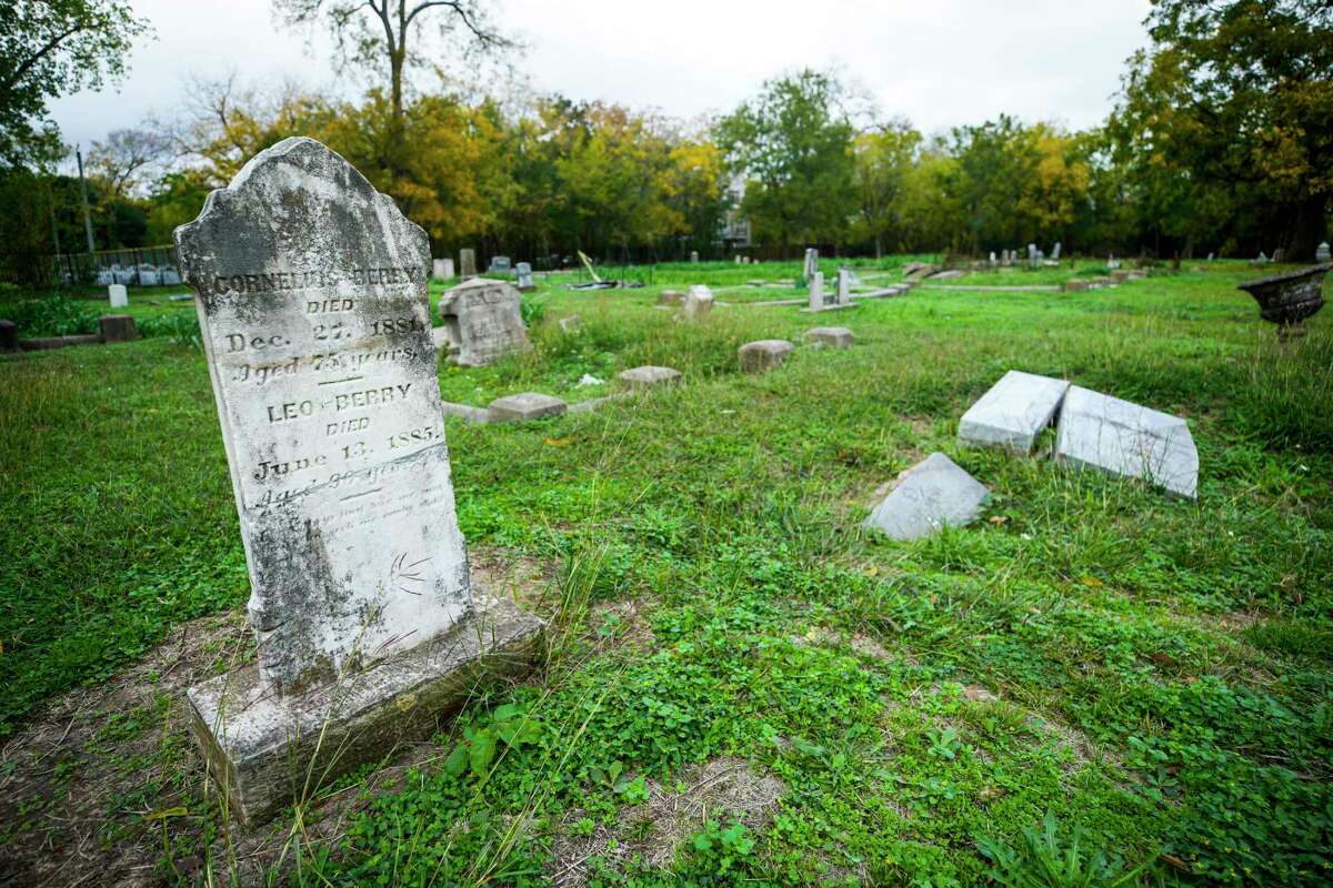 Gravesites at Olivewood Cemetery are shown on Monday, Dec. 5, 2022 in Houston. Caretakers at the historically Black cemetery say a neighboring contractor tore down a newly installed fence and built a wall footer on the cemetery's property.