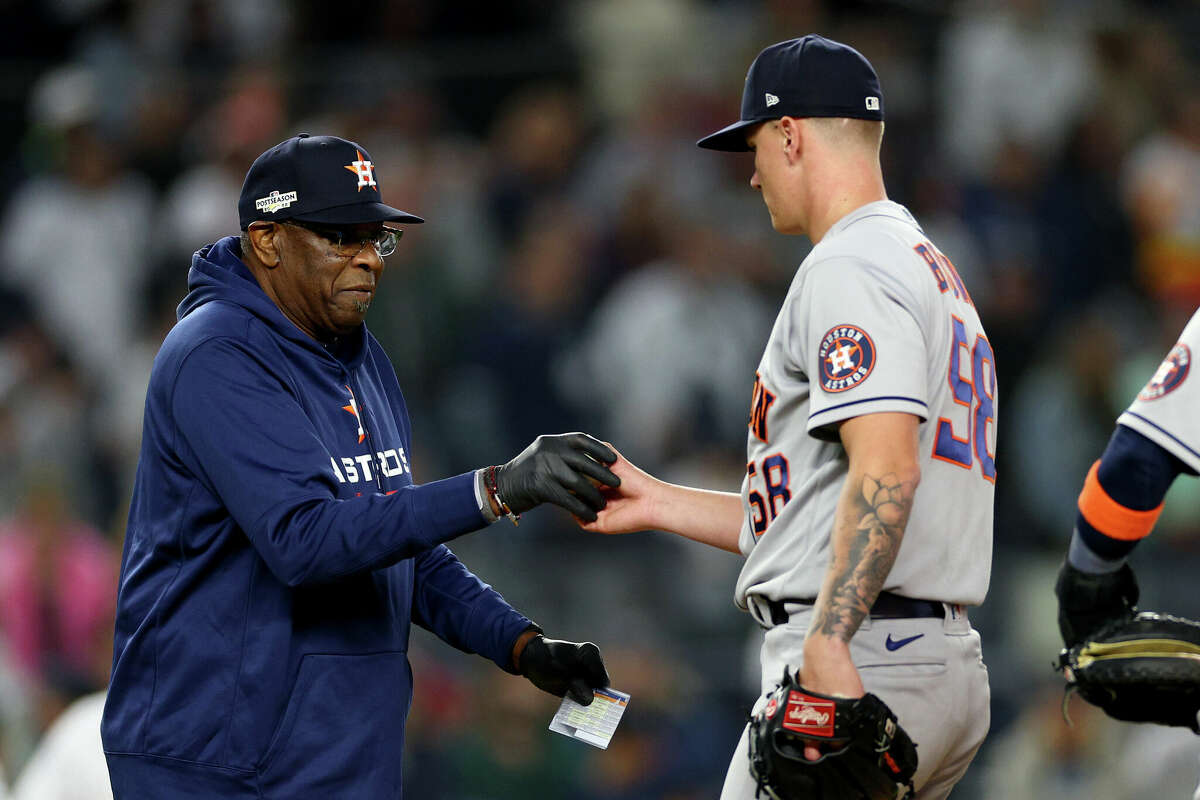 Manager Dusty Baker Jr. #12 of the Houston Astros takes the ball from Hunter Brown #58 as he is removed from the game against the New York Yankees during the eighth inning in game three of the American League Championship Series at Yankee Stadium on October 22, 2022 in New York City.