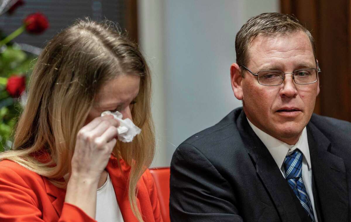 Jamie Davidson, right, talks Monday, Dec. 5, 2022 in his attorney’s office while his wife, Jacklyn Davidson, wipes her eyes, about the couple’s arrests on charges of interfering with child custody. Child Protective Services has been investigating the couple and their six young children and officials said Jacklyn Davidson fled with the children on Nov. 30 after Child Protective Services was granted temporary custody of them.