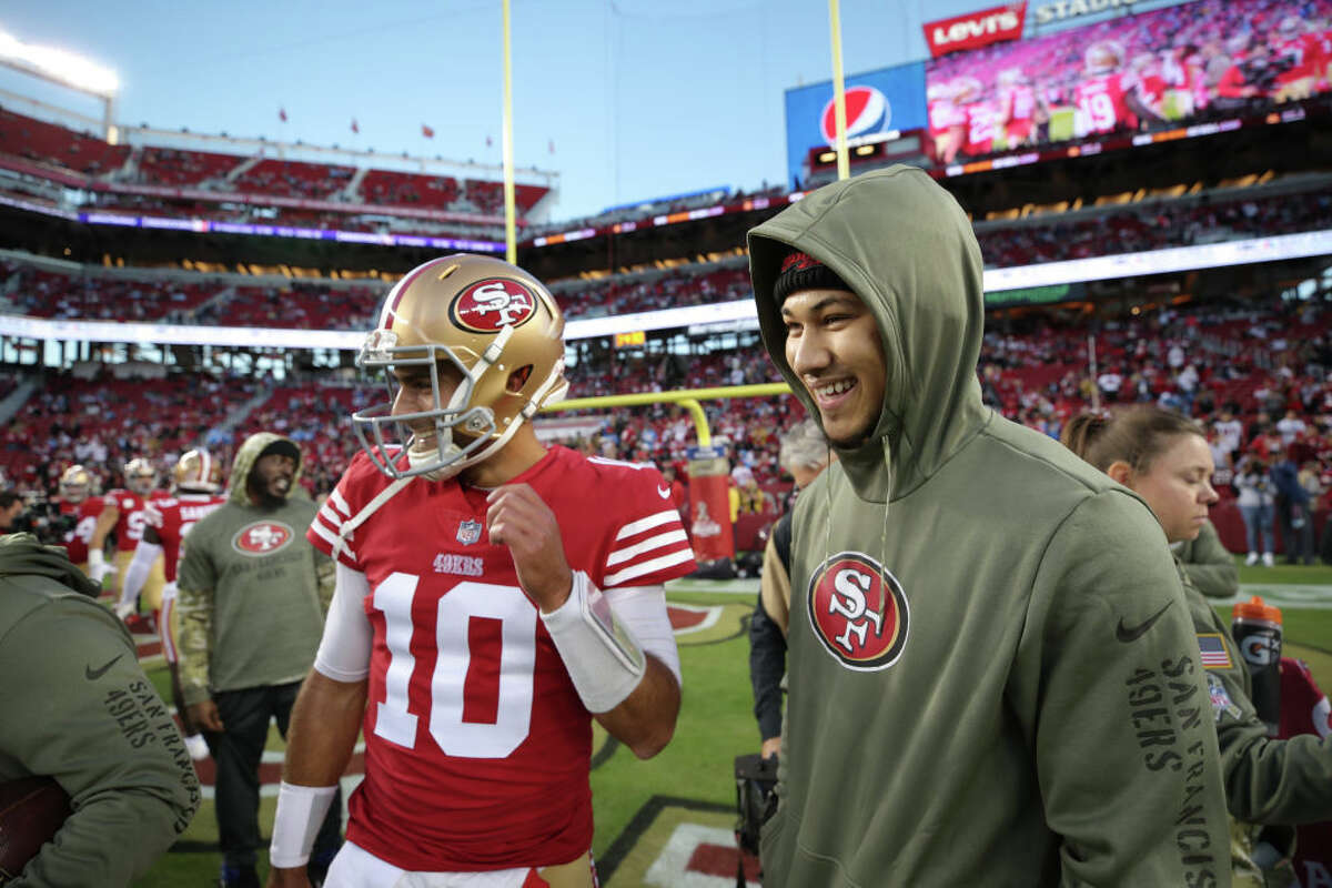 Jimmy Garoppolo and Trey Lance of the San Francisco 49ers on the field before the game against the Los Angeles Chargers at Levi's Stadium on November 13, 2022.