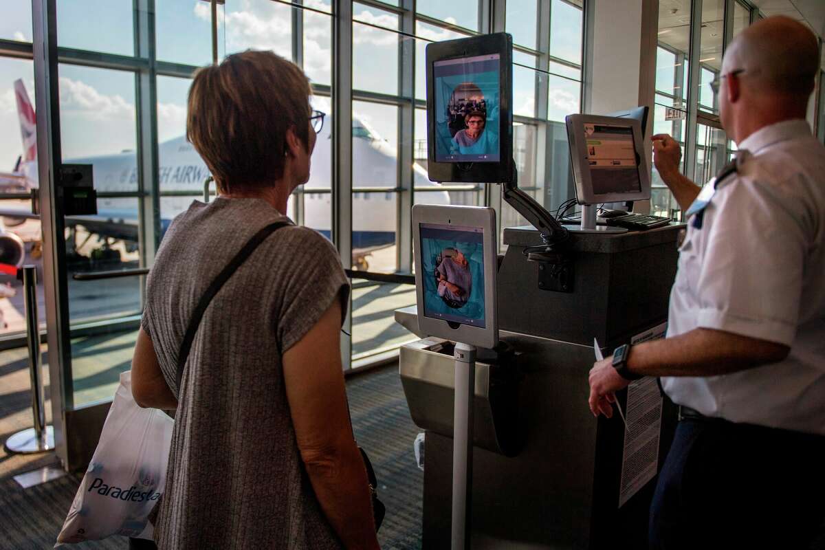 A woman boarding a flight to Copenhagen goes through facial recognition verification system at Dulles International Airport on Sept. 6, 2018. 