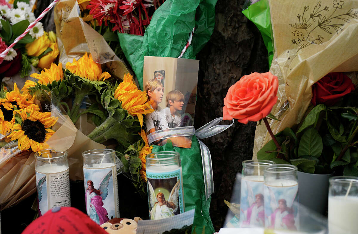 A memorial filled with candles, baseballs, flowers and photographs at the base of a tree near the baseball field at Tomball High School on Saturday, June 4, 2022 in Tomball, honoring The Collins family, grandfather Mark Collins, and his four grandchildren, Waylon, 18, Carson, 16, Hudson, 11, and their cousin, Bryson, 11, all killed by an escaped convict in Centerville.