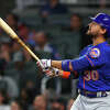Michael Conforto #30 of the New York Mets watches after hitting a ball deep for a home run during the eighth inning of the game against the Atlanta Braves at Truist Park on October 2, 2021 in Atlanta, Georgia.
