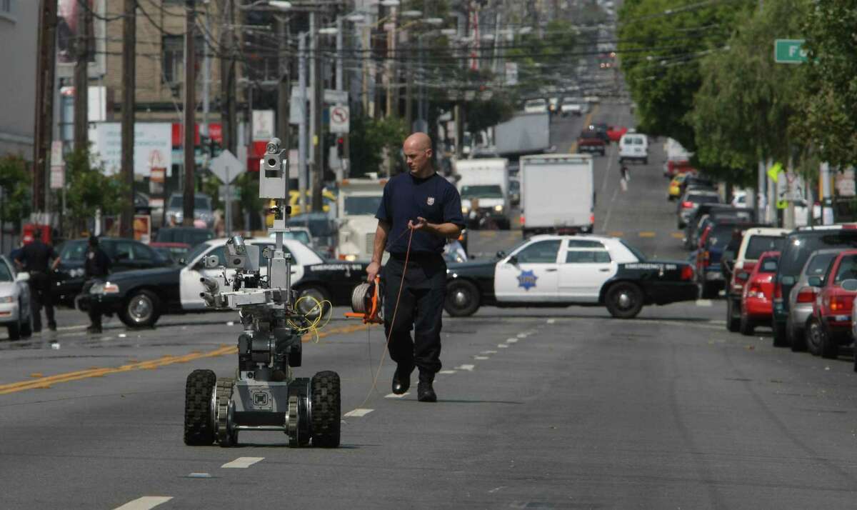 The San Francisco Police, bomb investigating robot, returns from down 16th street after looking over the device. The San Francsico Police bomb squard closed of 16th street between Folson and Harrison Streets, in San Francsico, Calif., after a report of a suspicious cart tied to a tree, on Friday July 25, 2008. Photo By Michael Macor/ The Chronicle