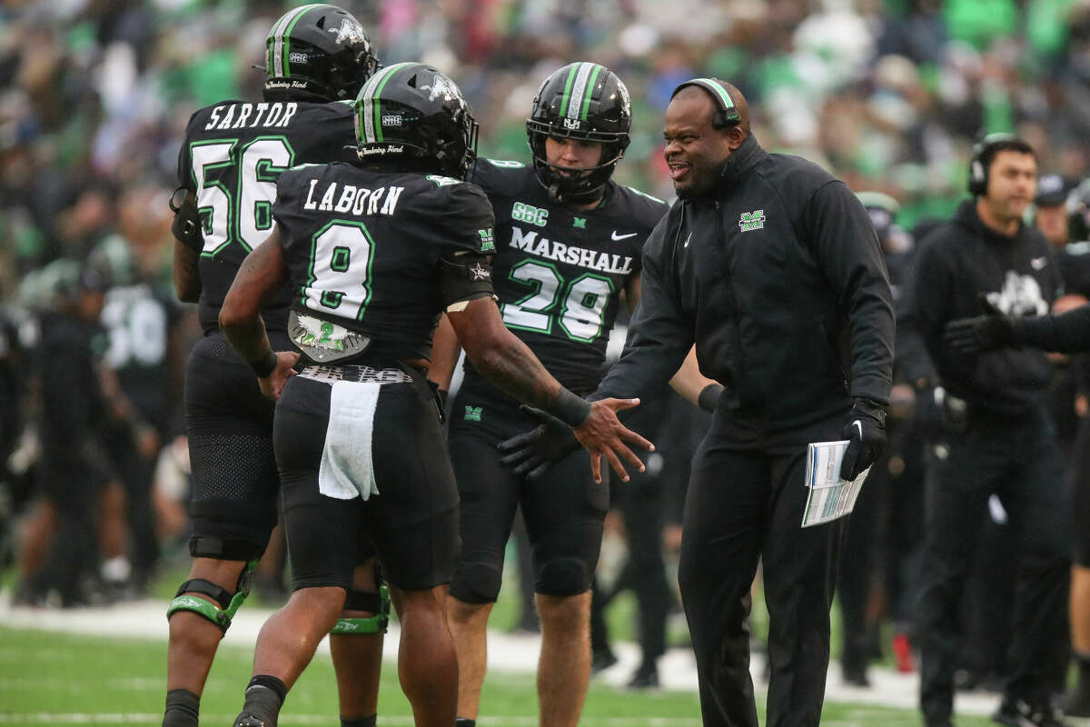 Marshall coach Charles Huff greets Khalan Laborn (8) after a touchdown against Appalachian State during an NCAA college football game Saturday, Nov. 12, 2022, in Huntington, W.Va. (Sholten Singer/The Herald-Dispatch via AP)