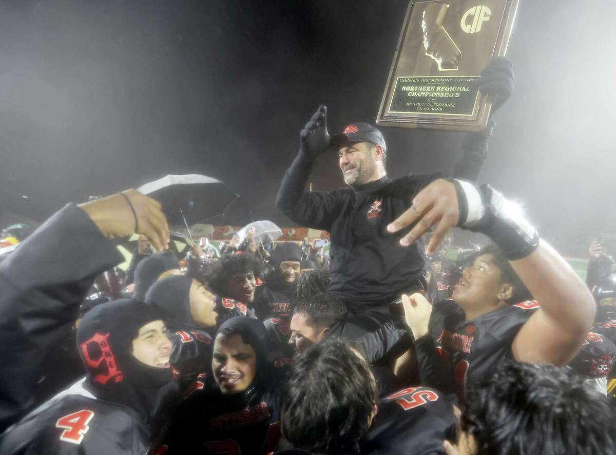 Pittsburg head coach Vic Galli is hoisted by his players after the Pirates won the Northern California 1-A title. Galli has announced that he is retiring after this season.
