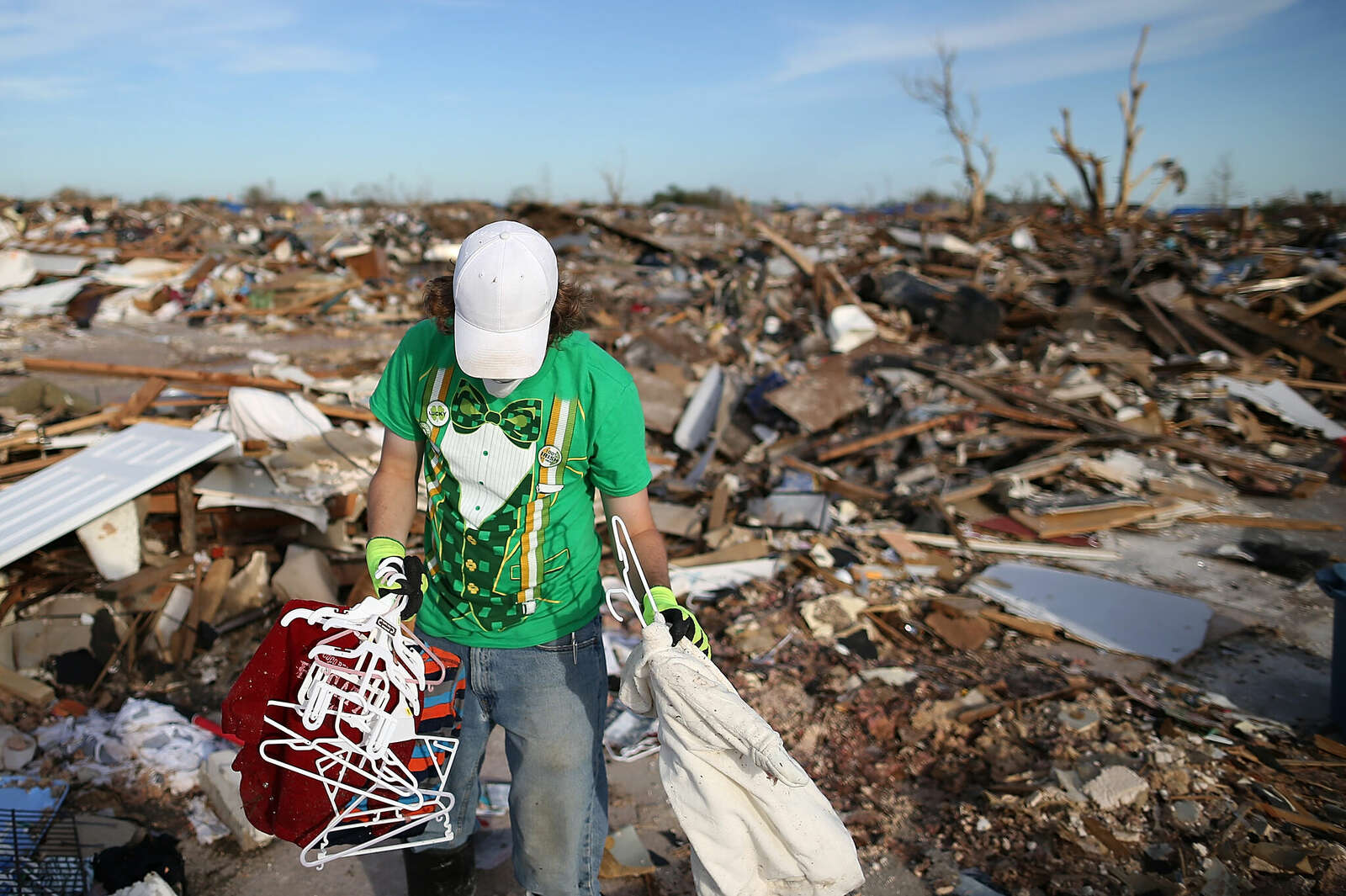 Brian Vitsmun sorts through debris at his home that was destroyed by a tornado on June 2, 2013 in Moore, Oklahoma.