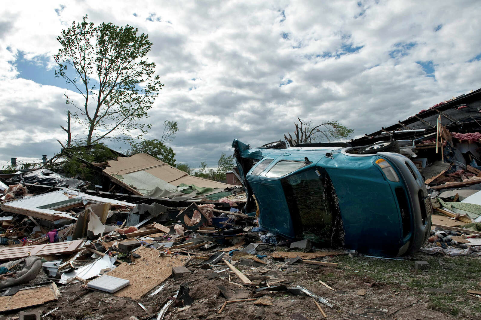 Damage including a car on its side is seen after an EF3 tornado swept through the Pinaire Mobile Home Park on April 15, 2012 in Wichita, Kansas.