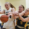 Father McGivney's Sami Oller, left, and Julie Stobie, center, battles for a rebound against Metro-East Lutheran's Lexi Bozarth on Monday in Gateway Metro Conference action in Glen Carbon.