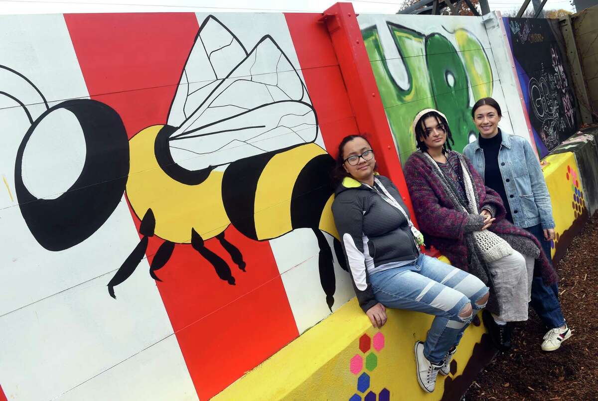 From left, Alex Guzman, 18, junior bee instructor, Gianna Strode, 19, operations assistant, and Huneebee Project founder and executive director Sarah Taylor are photographed at the Huneebee Project's Rosette Street Garden in New Haven on December 6, 2022.