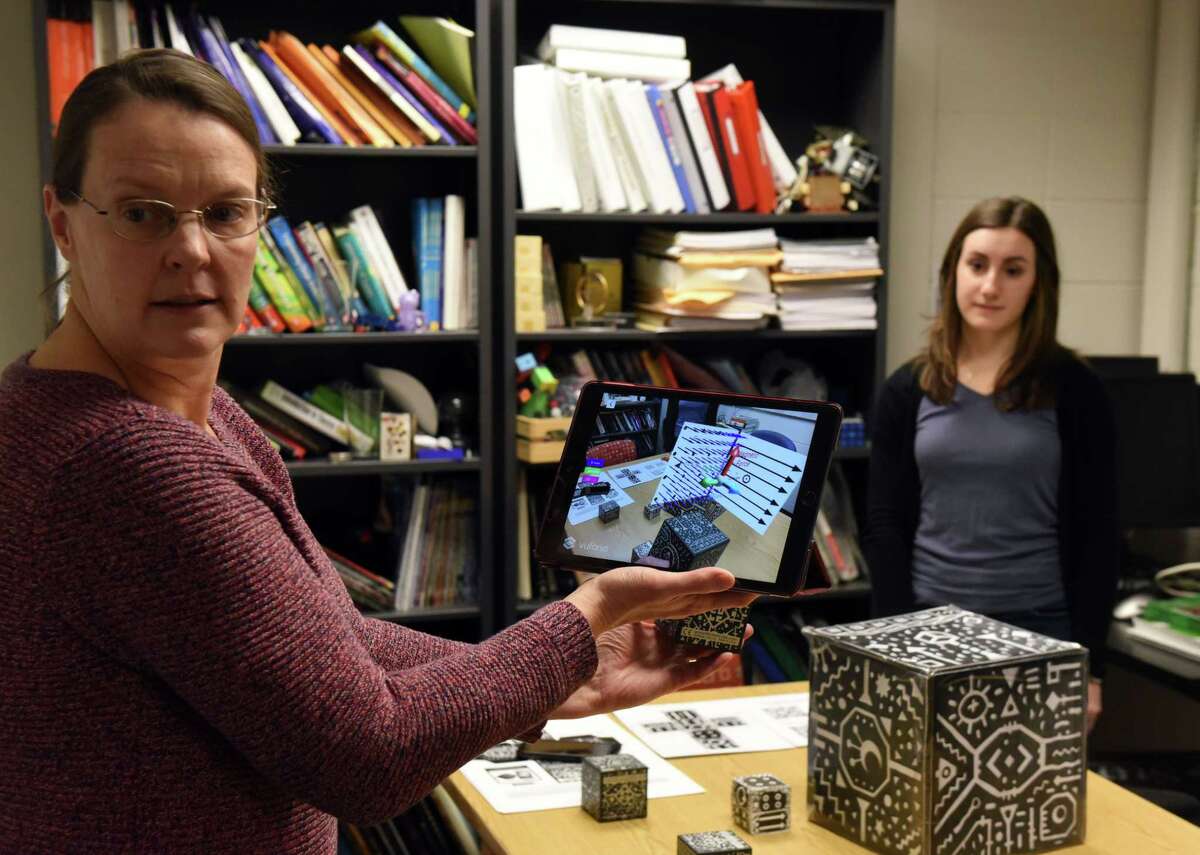 Siena College physics prof  Michele McColgan demonstrates an "augmented reality" exertion  illustrating magnetic forces connected  Tuesday, Dec. 6, 2022, astatine  Siena College successful  Colonie, N.Y. McColgan received a $300,00 assistance   from the National Science Foundation to assistance   physics students make   spatial reasoning skills, which could peculiarly  assistance   women enactment   successful  physics.