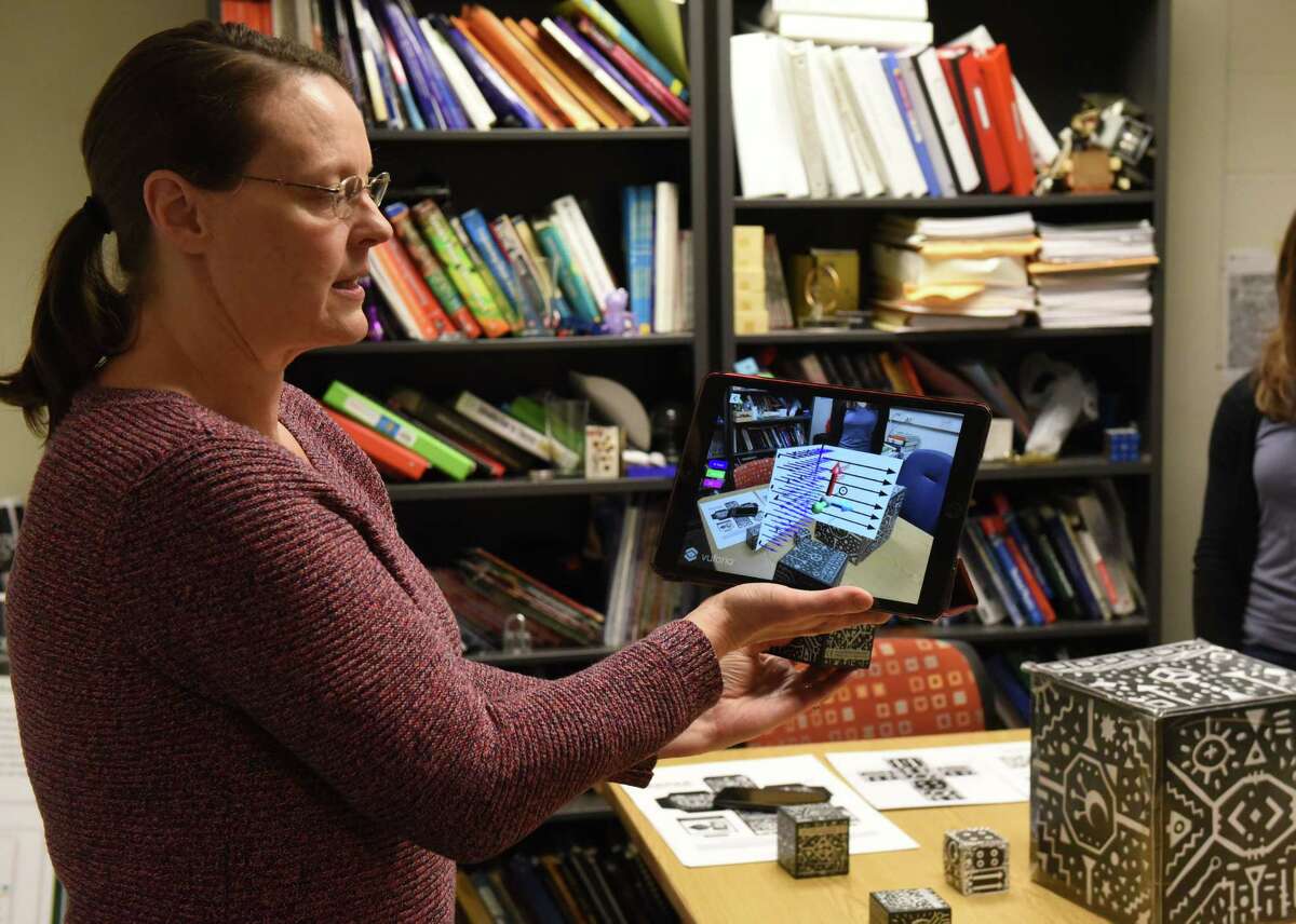 Siena College physics prof  Michele McColgan demonstrates an "augmented reality" exertion  illustrating magnetic forces connected  Tuesday, Dec. 6, 2022, astatine  Siena College successful  Colonie, N.Y. McColgan received a $300,00 assistance   from the National Science Foundation to assistance   physics students make   spatial reasoning skills, which could peculiarly  assistance   women enactment   successful  physics.