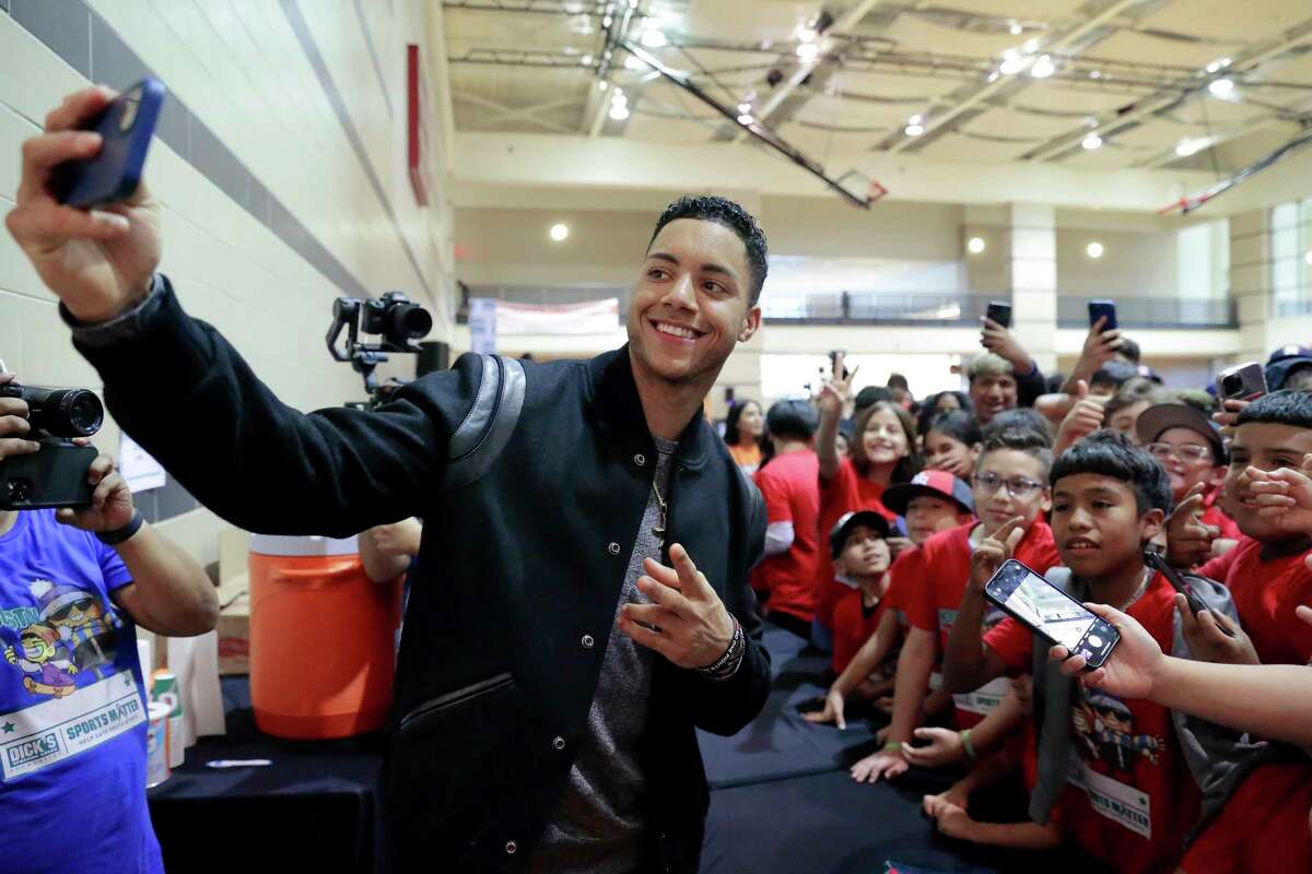 Houston Astros 2022 World Series baseball MVP Jeremy Pena takes a selfie with kids after speaking at Sports Matter Day at the University of Houston, Saturday, Dec. 3, 2022, in Houston.
