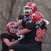 New Canaan's Luke Reed (25), Will Pepe (99) and Thomas Garcia (42) celebrate a touchdown against Cheshire during the CIAC Class L football semifinals at Dunning Field on Sunday, Dec. 4, 2022.