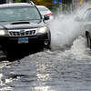 FILE PHOTO: Cars drive through flooding on Water Street in 2021.