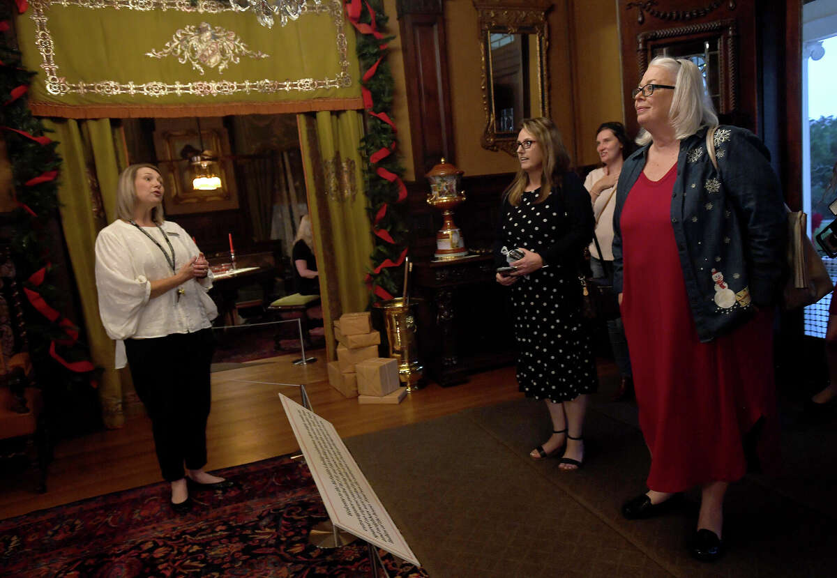 Rayanna Hoeft, Director of Educational Programming, welcomes educators as they begin their tour in the holiday decorated McFaddin-Ward House during an Educator Appreciation night at the historic home museum Tuesday. Photo made Tuesday, December 6, 2022 Kim Brent/Beaumont Enterprise