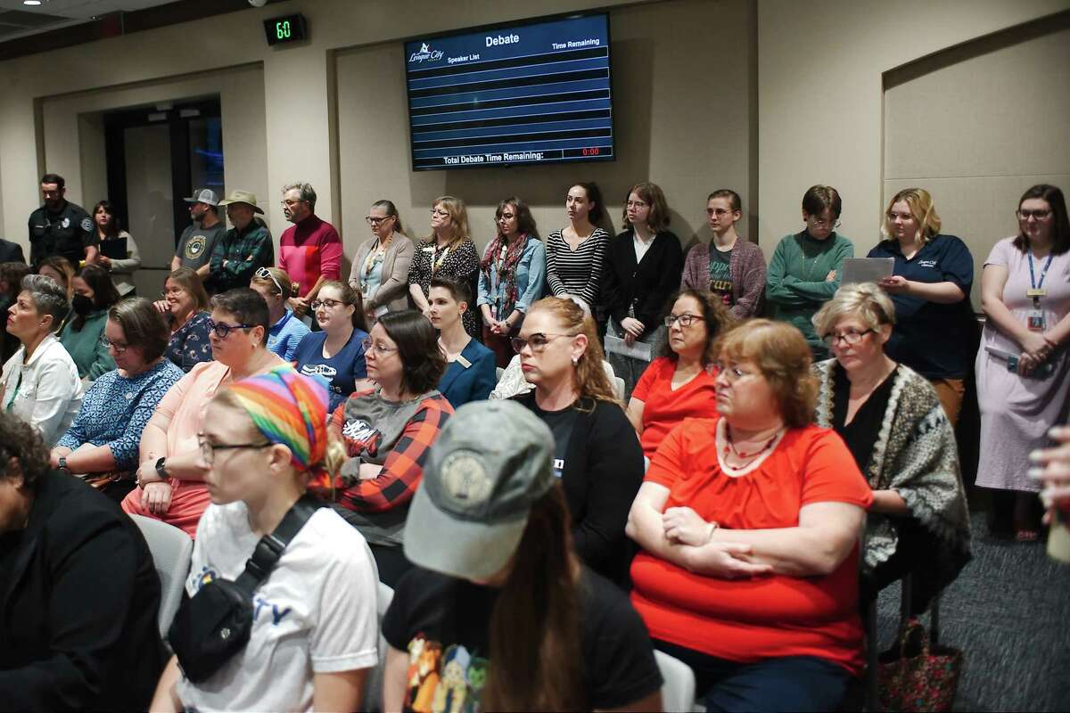 In this file photo, League City administrative and library staff elect to stand as seating capacity is limited during a City Council meeting Tuesday, Dec. 6, 2022, to hear a proposal that denies use of tax dollars to purchase books for the library on subjects that include gender identity, sexual orientation and related topics.