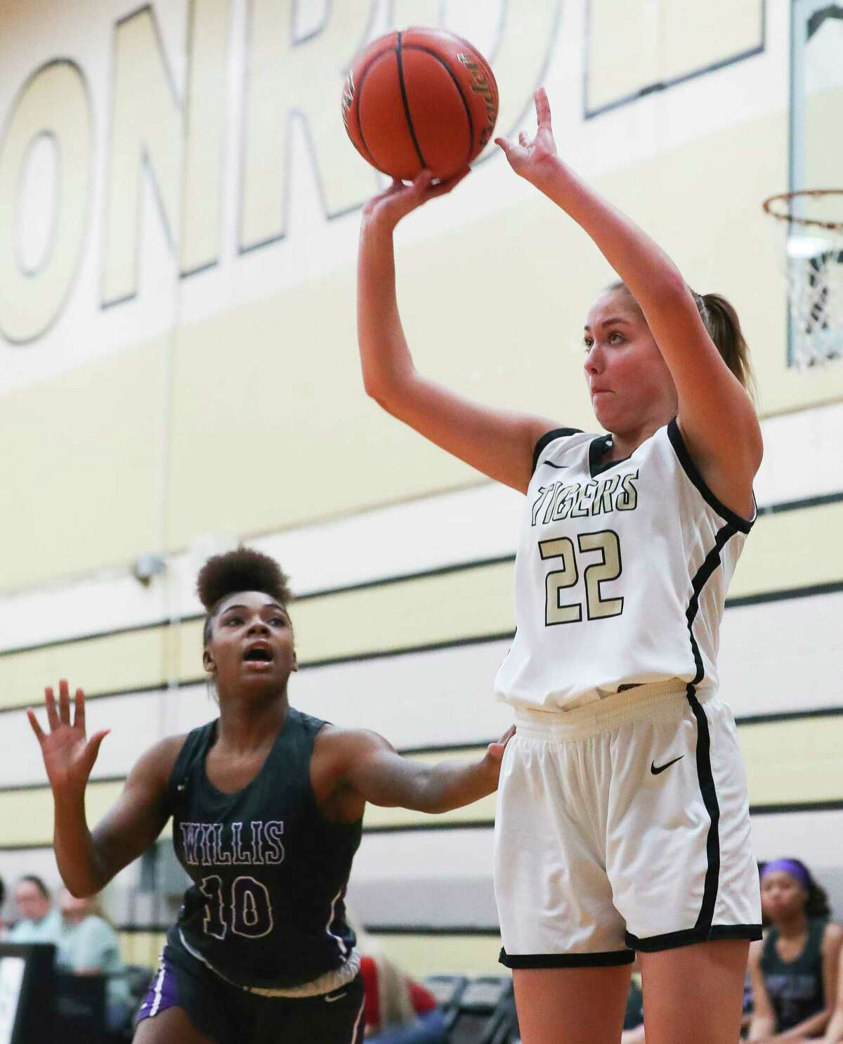 Conroe's Luisa Hamann (22) shoots a 3-pointer past Willis' Trrinity Davis (10) during the second quarter of a District 13-6A high school basketball game at Conroe High School, Tuesday, Dec. 6, 2022, in Conroe.