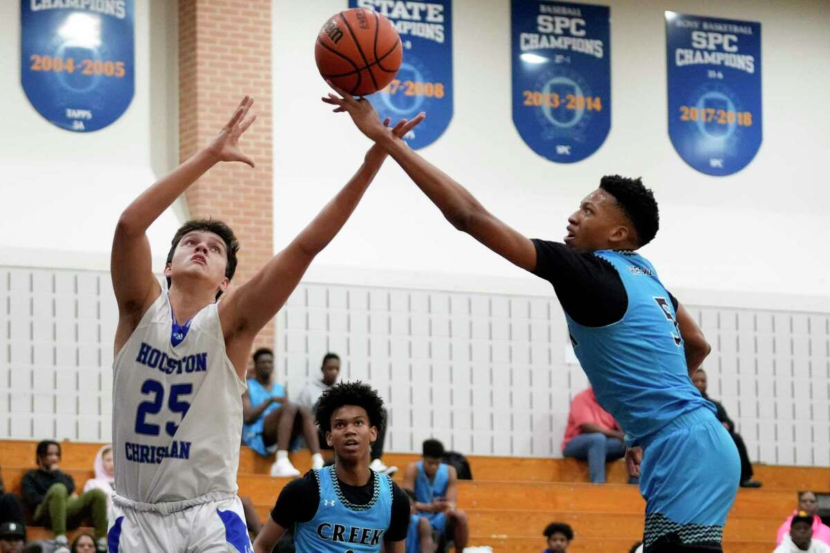 Houston Christian guard Dominic Cestero (25) and Shadow Creek forward Kaden Tate leap for a rebound during the first half of a high school basketball game, Tuesday, Dec. 6, 2022, in Houston.