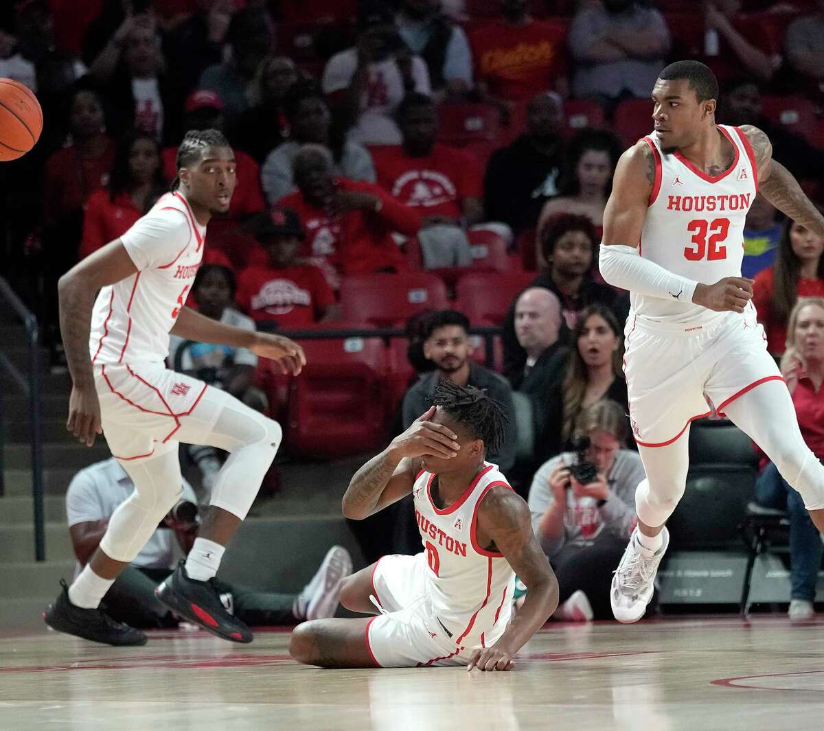 Houston Cougars guard Marcus Sasser (0) reacts after an injury to his face during the first half of an NCAA men’s basketball game at the Fertitta Center on Tuesday, Dec. 6, 2022 in Houston.