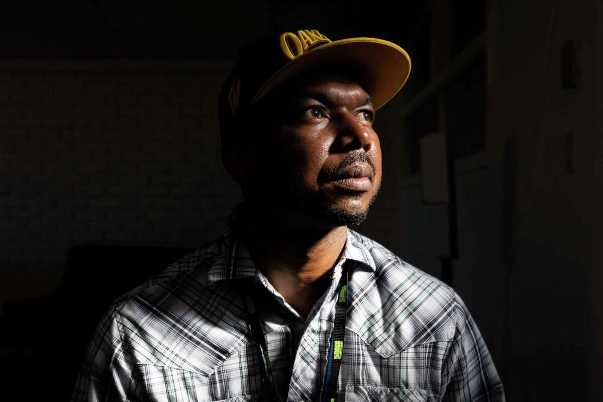 John Jones III sits in his office at Building Opportunities for Self-Sufficiency in Oakland, Calif. Wednesday, May 4, 2022. The housing advocate, who spent a year-and-a-half experiencing homelessness following his release from prison in 2012, said he found permanent housing in 2020, after Oakland passed a law banning criminal background checks as a condition to housing. He was involved in the campaign to get Alameda County supervisors to do the same on Tuesday, Dec. 6, 2022.