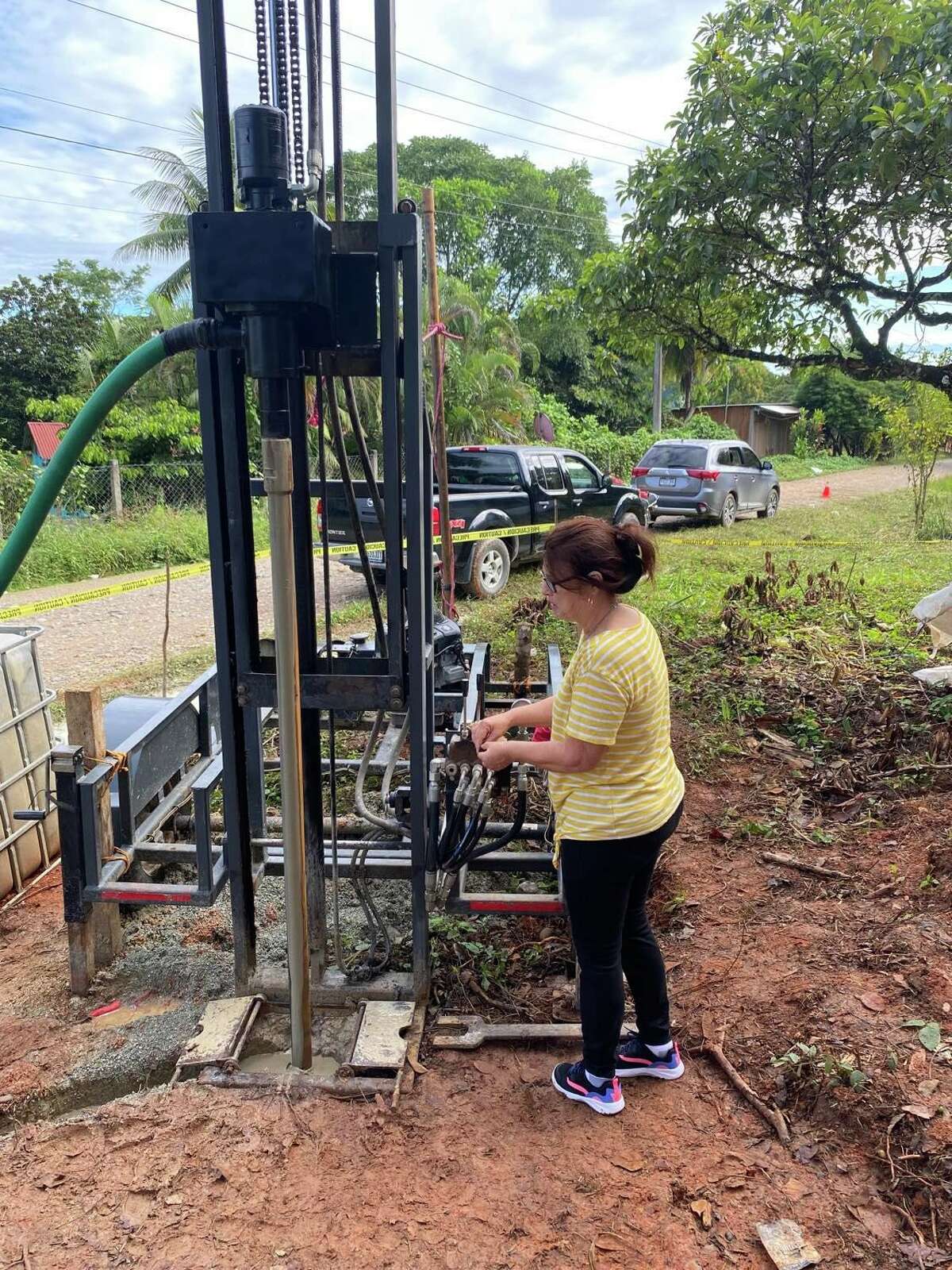 Mustard Seed Peace Project founder and president Teresa Cranmer moves a lever and it activates the well that was drilled in the small community of Virginia in Guatemala.