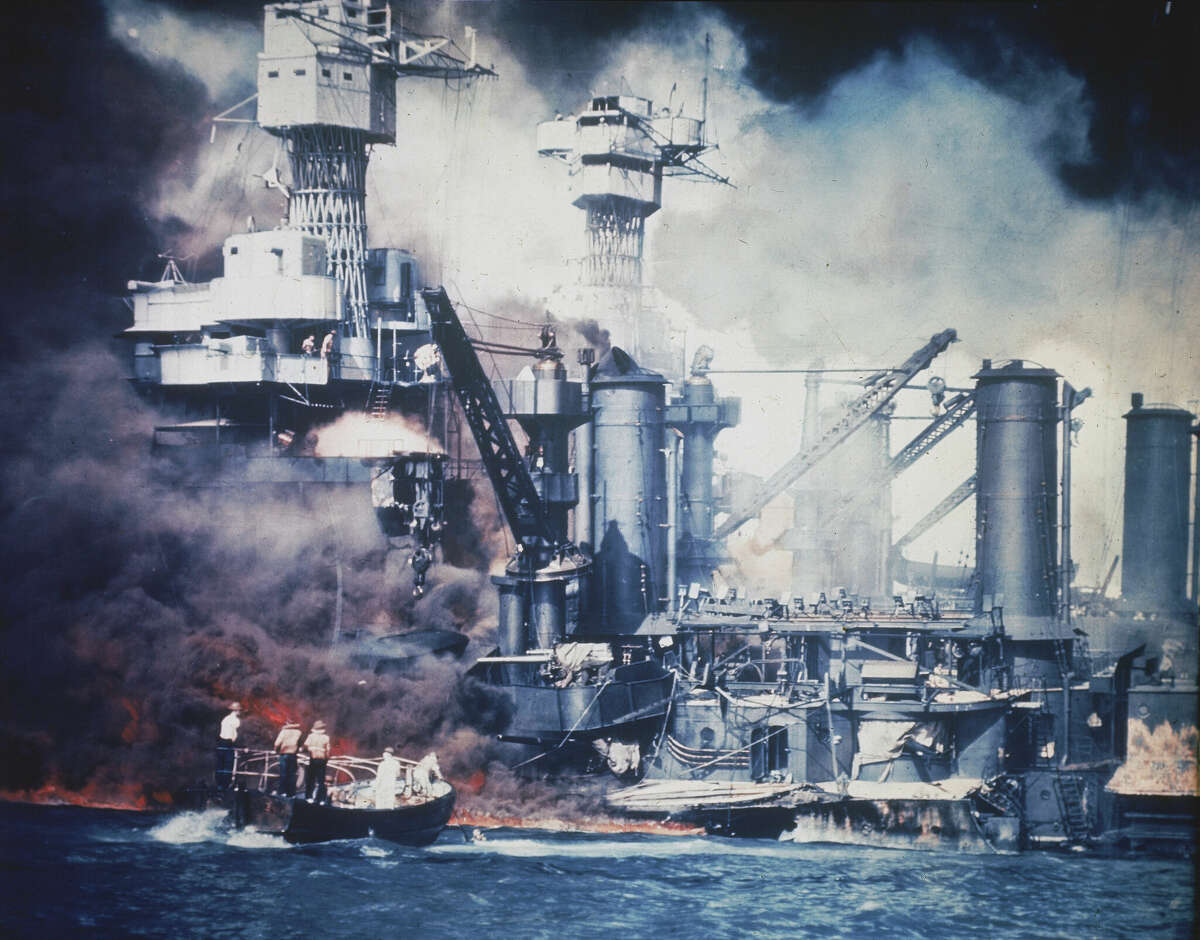A small boat rescues a USS West Virginia crew member from the water after the Japanese bombing of Pearl Harbor, Hawaii, on Dec. 7, 1941. A few centenarian survivors of the attack on Pearl Harbor are expected to gather at the scene of the Japanese bombing on Wednesday, Dec. 7, 2022, to remember those who perished 81 years ago. 