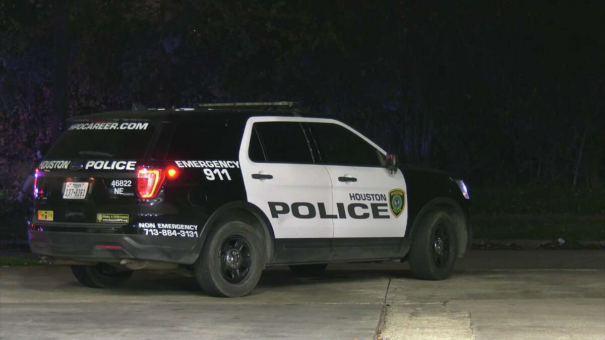 A Houston police car waits at the scene of a shooting in east Houston.
