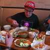 Capital Region musician Rick Bedrosian, right, samples Thai food at a Queens restaurant in a scene from Bedrosian's new online TV series, "I Could Eat," which follows him on food adventures. His companions are Quees-based food writer Joe DiStefao, center, and Bedrosian's sidekick for the first episode of the series, Jayme Albin, who is the audio engineer for Bedrosian's band Hair of the Dog. 