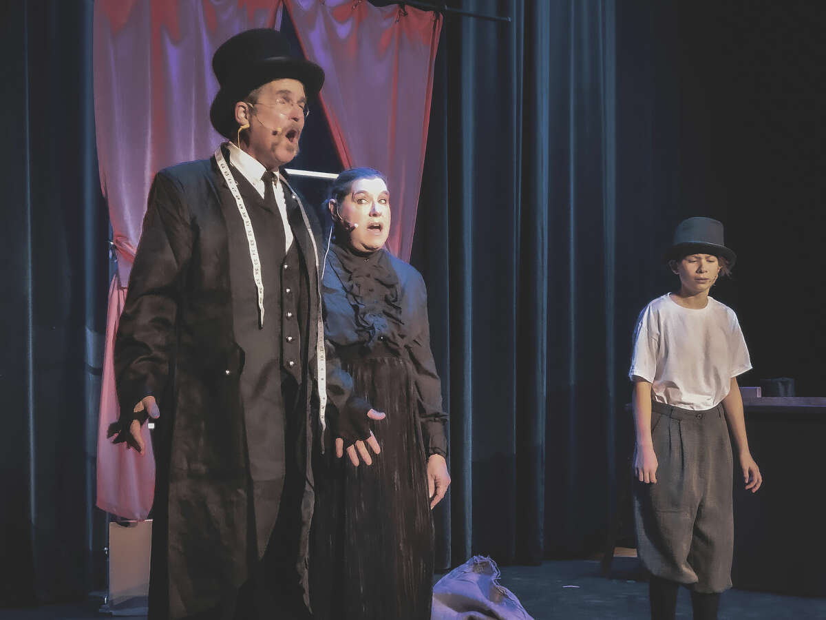 From left, David Minor and Colleen Granada, as Mr. and Mrs. Sowerberry, perform a song with Allison Ladd, as Oliver, in the funeral parlor as part of the Manistee Civic Players' production of "Oliver." The show runs Dec. 9-11 and Dec. 16-18 at the Ramsdell Regional Center for the Arts.