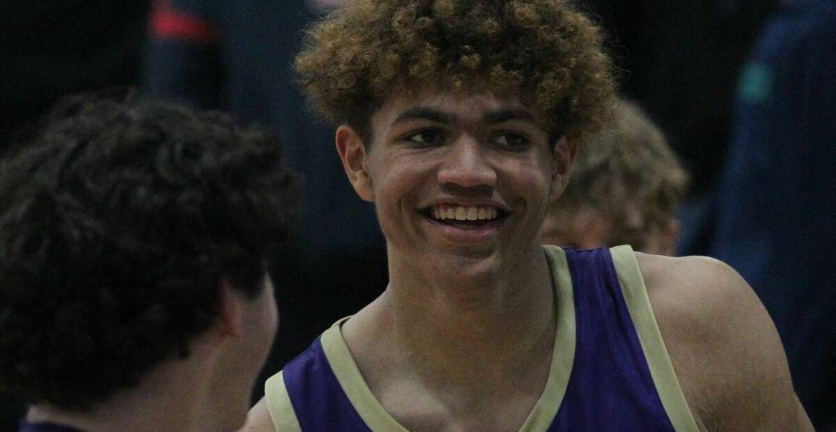 Routt's Michael Wilson smiles as he walks off the court after the Rockets' 63-36 win at Triopia Tuesday night.