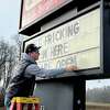 Frick's Sports Bar co-owner Kurt Busard arranges a sign announcing the opening of the restaurant on Wednesday, Dec. 7, 2022.