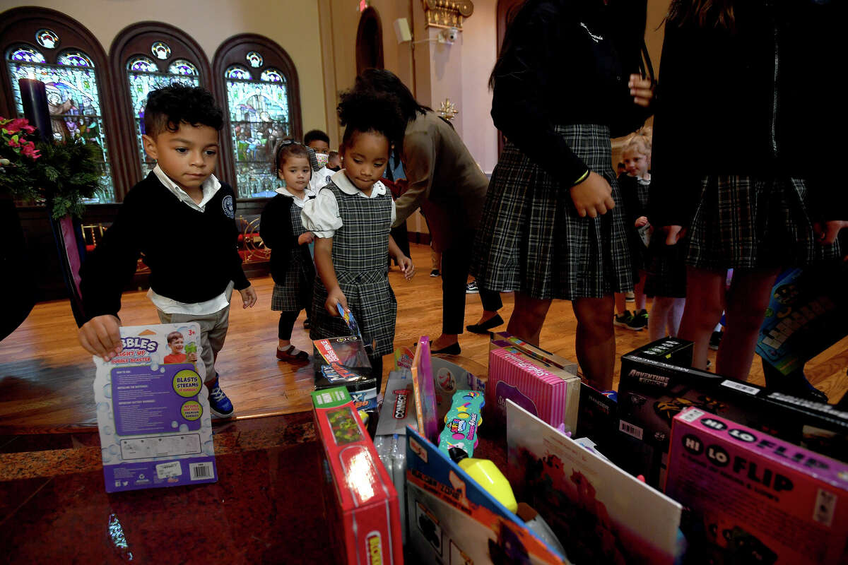 Students at St. Anthony Cathedral Basilica School bring their toys to the altar for a blessing during the annual "Blessing of the Toys" mass Wednesday. All the toys collected were donated to the Enterprise Empty Stocking Fund and will be given out to children in need at next week's distribution. Photo made Wednesday, November 30, 2022 Kim Brent/Beaumont Enterprise