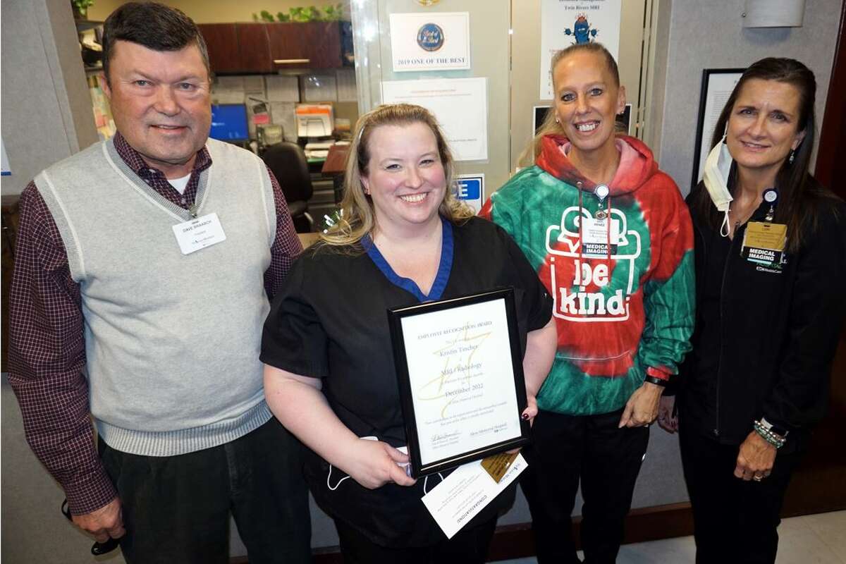 Kristin Tincher, holding plaque, of Twin Rivers MRI, is Alton Memorial Hospital’s December Employee of the Month. She received the honor Dec. 6 from AMH President Dave Braasch and her co-workers, Renee Roady and Lori Moore. 