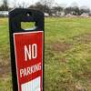 Tweed New Haven Regional Airport operator Avports LLC has put a "No Parking" sign in an area near the airport's remote parking lot where vehicles were found parked on the grass in an unauthorized area.