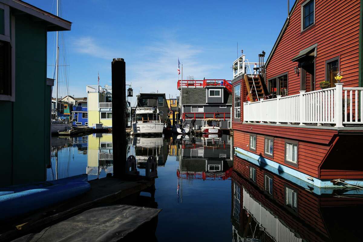 At right, floating homes are tied down at Barnhill Marina on Wednesday, November 30, 2022, in Alameda, Calif. Owners at the marina have become unlikely champions in a rent control battle that's erupted throughout the state.