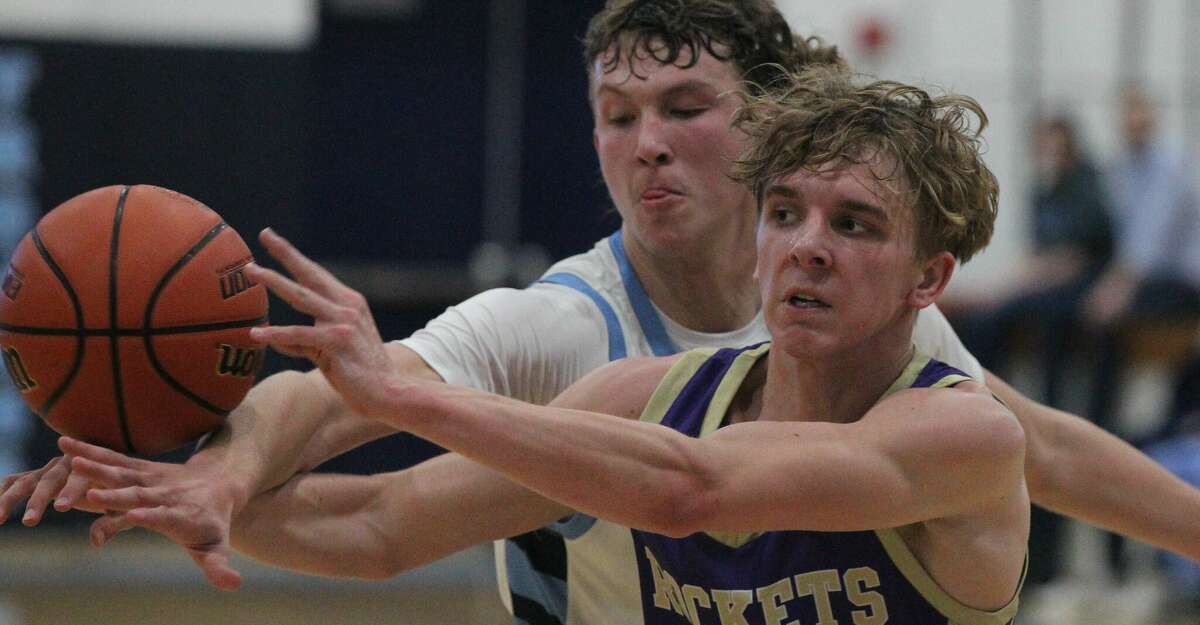 Routt's Will Merwin passes the ball under pressure from Triopia's Aiden Neathery during a boys' basketball game at Triopia on Tuesday.