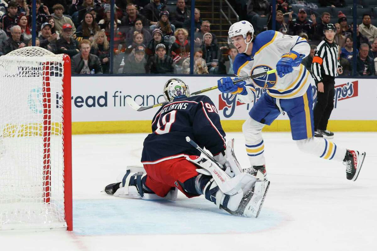 Buffalo Sabres' Tage Thompson, right, scores a goal against Columbus Blue Jackets' Elvis Merzlikins during the first period of an NHL hockey game Wednesday, Dec. 7, 2022, in Columbus, Ohio.