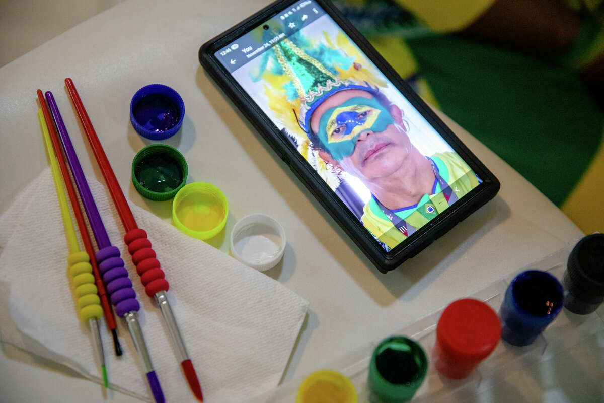 A picture on Brazilian Wallace Leite's phone shows how he wants his face paint to be drawn before the Brazil and Switzerland World Cup game in Doha, Qatar on November 28, 2022.