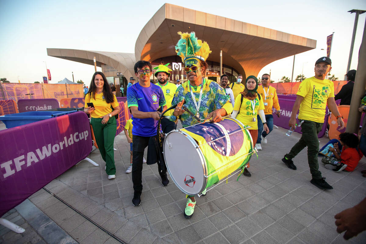 Brazilian Wallace Leite (center) and Lucivaldo Costa (second from left) exit the Doha Metro and walk to Stadium 974 before the Brazil and Switzerland World Cup game in Doha, Qatar on November 28, 2022.